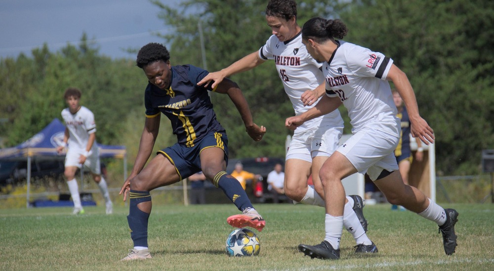 Timi Aliu protecting the ball from a couple of Ravens - Mark Wilson