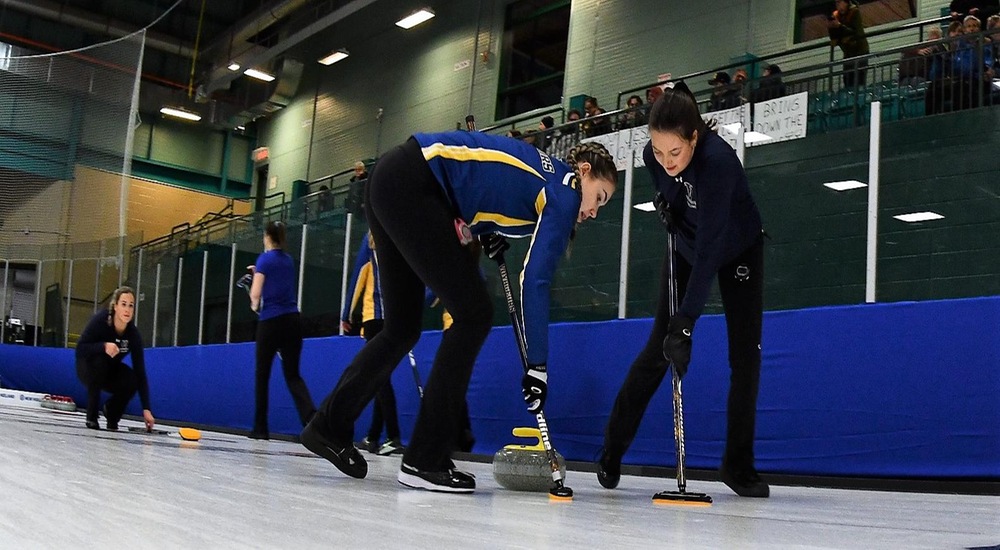 Piper and Abby sweep a stone - Curling Canada/Duncan Bell